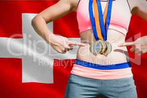 Composite image of close up of sportswoman chest with medals