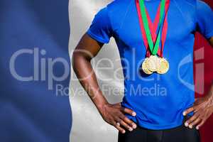Composite image of portrait of athletic man chest holding gold m