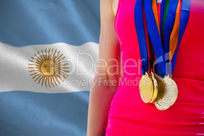 Composite image of portrait of sportswoman chest with medals