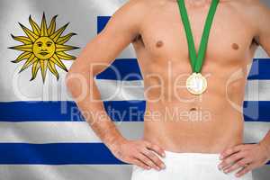 Composite image of athlete posing with gold medal on white backg