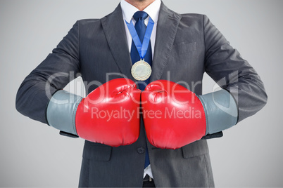 Composite image of businessman with boxing gloves