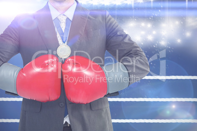 Composite image of businessman with boxing gloves