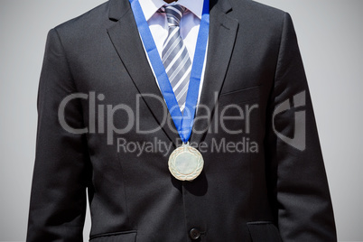 Composite image of close up of businessman chest with medal