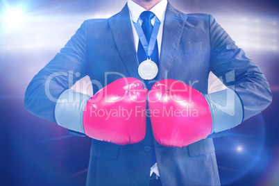 Composite image of businessman with boxing gloves