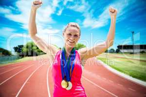 Composite image of portrait of happy sportswoman is winning