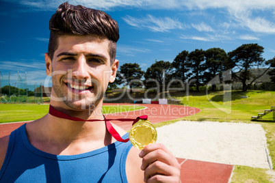 Composite image of portrait of happy sportsman is showing his me