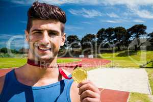 Composite image of portrait of happy sportsman is showing his me
