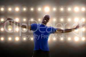 Composite image of happy sportsman smiling and holding medals