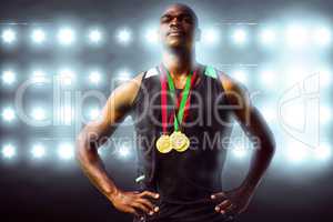 Composite image of athletic man posing with his medals