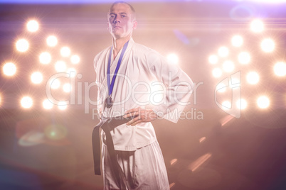 Composite image of fighter posing with medal around his neck