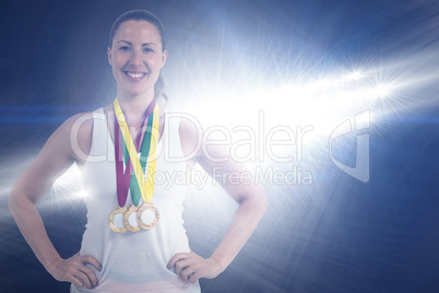 Composite image of athlete posing with gold medals around his ne