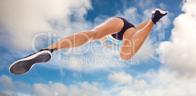 Composite image of low angle female athlete jumping