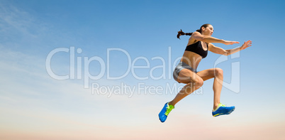 Composite image of sporty woman jumping