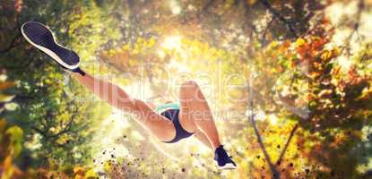 Composite image of low angle female athlete jumping