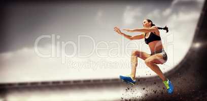 Composite image of sporty woman jumping