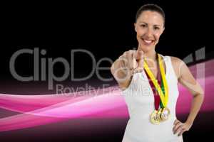Composite image of female athlete posing with gold medals around