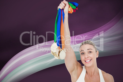 Composite image of happy female athlete holding medals