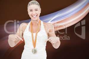 Composite image of female athlete pointing her medal