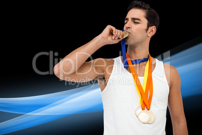Composite image of happy athlete kissing medal