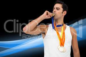 Composite image of happy athlete kissing medal