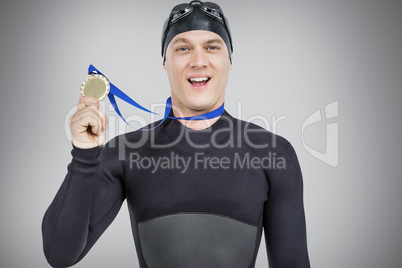 Composite image of swimmer showing his gold medal