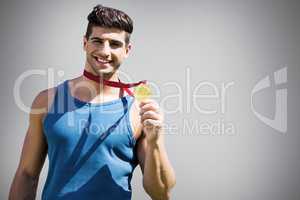 Composite image of attractive man showing medal