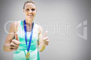 Composite image of portrait of smiling sportswoman holding a med
