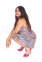 Pretty Indian woman crouching.