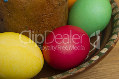 Easter eggs of different colors and cake