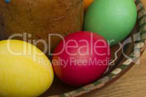 Easter eggs of different colors and cake