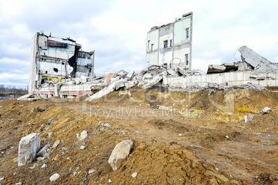 Pieces of Metal and Stone are Crumbling from Demolished Building