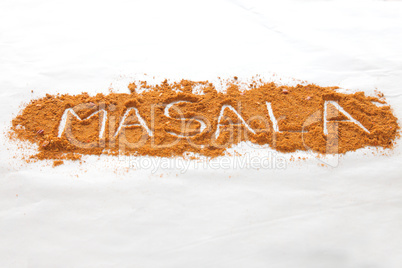 Masala text written in font of spices in perspective