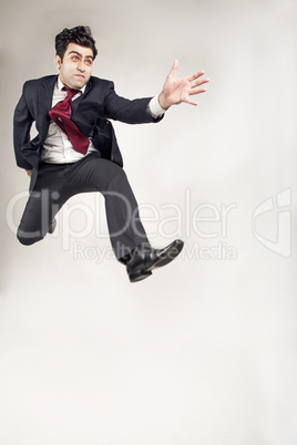 Man in Suit jumping high and forward