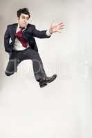 Man in Suit jumping high and forward