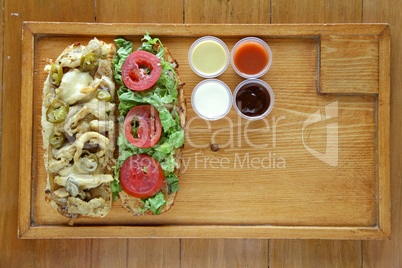Open face healthy meat and vegetable sandwich served with condim