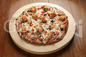 Prawn shrimp flat bread pizza served on a circular wooden board