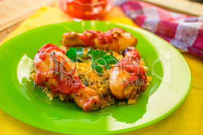 Chicken legs with tomato-orange sauce, rosemary and rice