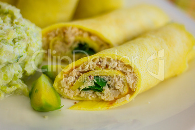 Rolls of egg pancake with turkey and mashed brussels sprouts