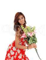 Surprised woman holding big flowers.