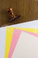 Wooden stamp and colored sheets of paper