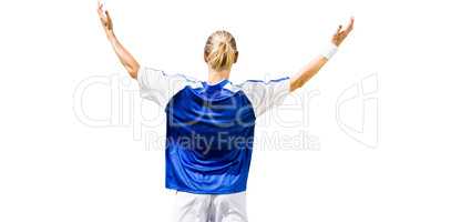 Rear view of sportswoman raising arms