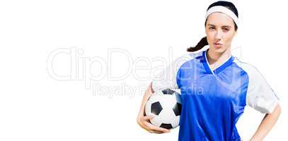 Woman football player posing with football
