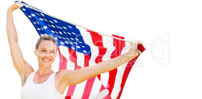 Portrait of happy sportswoman posing with an american flag
