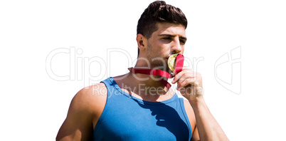 Portrait of sportsman kissing a medal