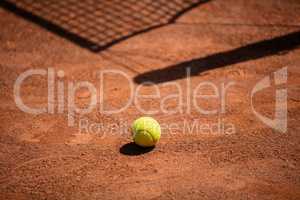 Tennis balls on the ground of clay court