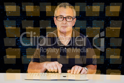 Man sitting at the computer keyboard in front Digital Wall