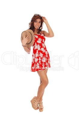 Young woman holding a brown cowboy hat.