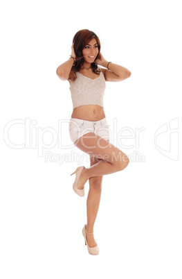 Woman standing in shorts on one leg.