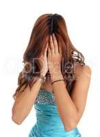 Woman covers face with hands.