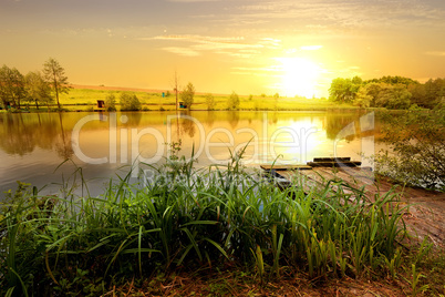 Yellow sunset on pond